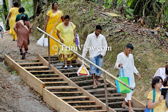 Pilgrims descend makeshift stairs to wthe river