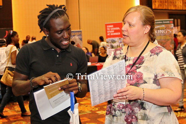 Ms. Cheryl Ernst, representative from Southern Illinois University assisting a student