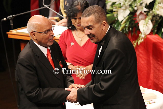 (L) Pastor Clive Dottin receives his Chaconia Medal, Silver