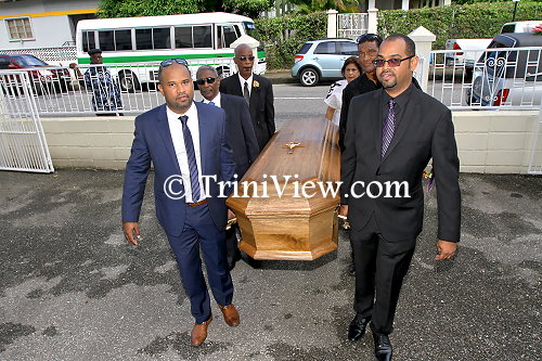 Entering the St. Theresa's R.C. Church compound, the Sons of Earl Crosby lead the pall-bearers carrying their father's casket